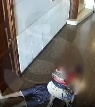 La víctima, tendida en el piso, y el ladrón robándole.